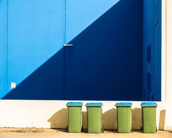 Empty chairs against blue sky on building