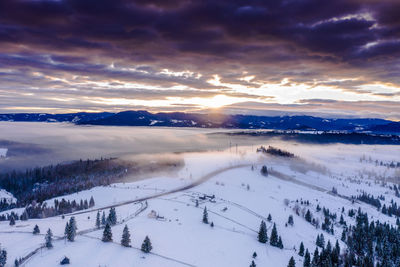 Scenic view of snowcapped mountains against sky during sunset