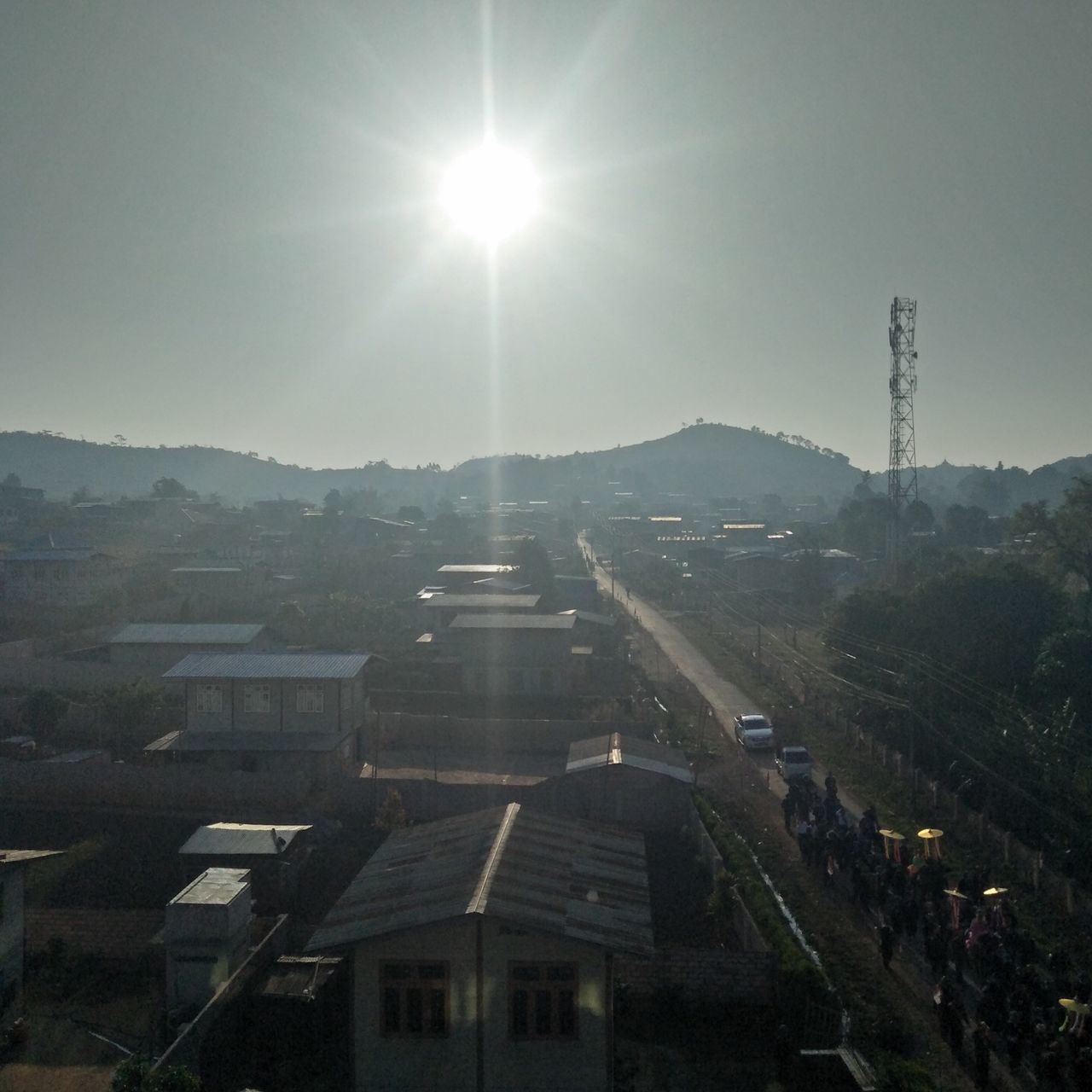 architecture, built structure, sky, building exterior, sun, sunlight, nature, sunbeam, lens flare, building, no people, day, city, outdoors, travel destinations, sunny, mountain, clear sky, high angle view, travel, bright