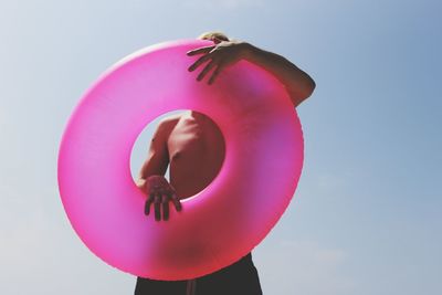 Low angle view of man with inflatable ring