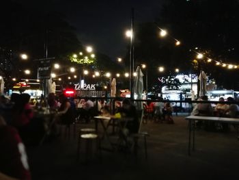 Empty chairs in restaurant at night