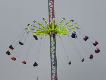 Low angle view of amusement park ride against sky