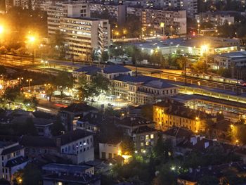 High angle view of city lit up at night