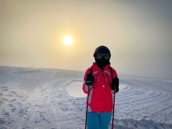 Woman skier on the slope on a foggy winter day