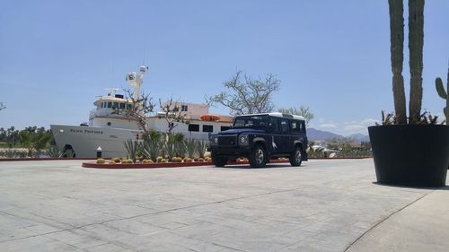 Cars on street against clear sky