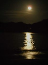 Scenic view of lake against sky at night