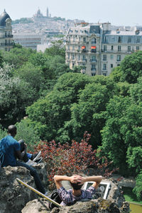 Men on rock formation at park in city