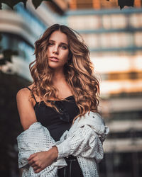 Portrait of a beautiful young woman standing outdoors