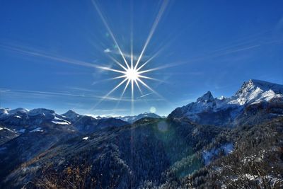 Scenic view of mountains against blue sky