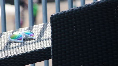 Close-up of black hanging on metal against wall