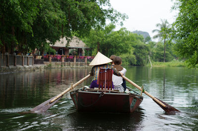 Boat in lake against trees