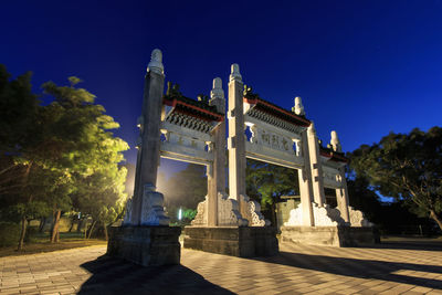 Entrance of martyr shrine against sky at night