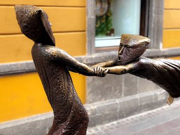 Close-up of statue against rusty metal