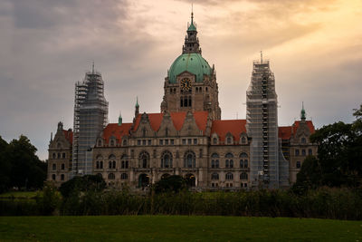 Buildings against cloudy sky