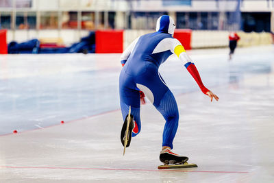 Full length of man ice skating on rink