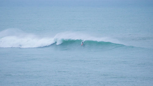 Scenic view of guethary and surfer