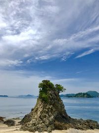 Rock formation on sea against sky