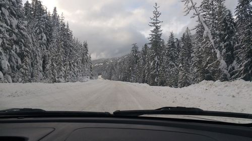 Road seen through car windshield during winter