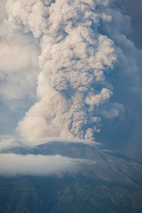 Aerial view of volcanic mountain against sky