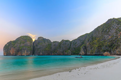 Scenic view of sea and mountains against sky