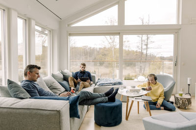 Father and children using wireless technology at home