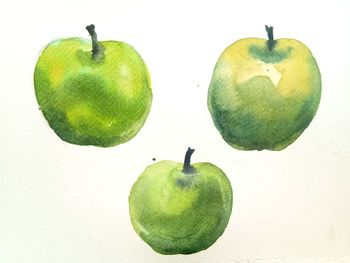 Close-up of apples on green background