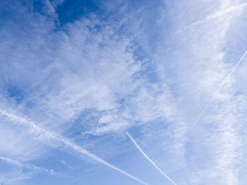 Low angle view of vapor trail in blue sky