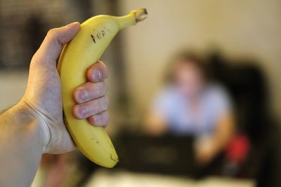 Close-up of hand holding banana