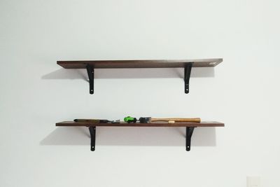 Empty chair on table against white background