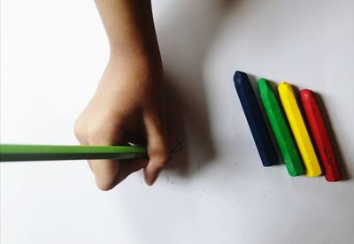 High angle view of woman with colored pencils