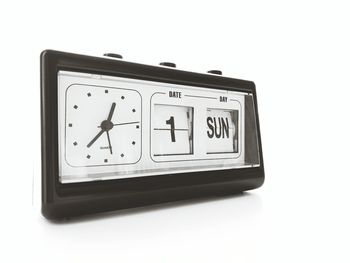 Close-up of clock over white background