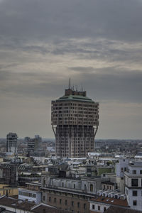 View of cityscape against cloudy sky