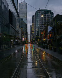 City street amidst buildings during rainy season