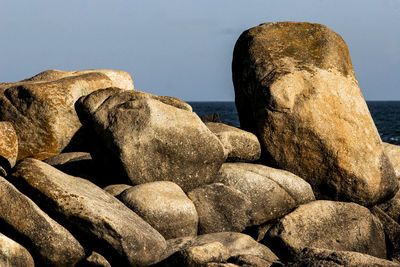 Rocks on beach against sky