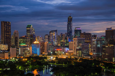 Illuminated buildings in city against sky