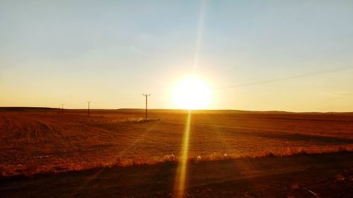 Scenic view of field against sky during sunset