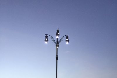 Low angle view of street light against blue sky
