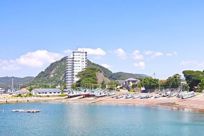 View of building by sea against sky