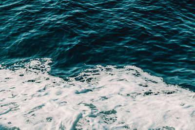 High angle view of surf on sea shore