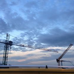 Crane against cloudy sky