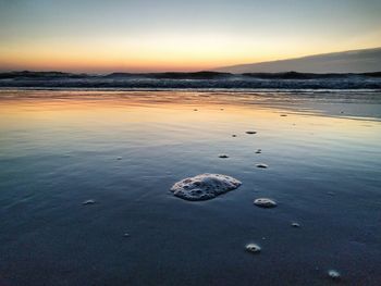 Scenic view of sea against sky at sunset