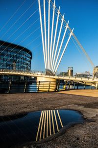 Low angle view of bridge against clear blue sky