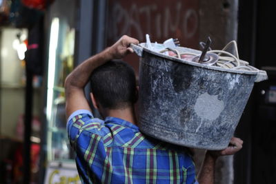 Rear view of man holding bag