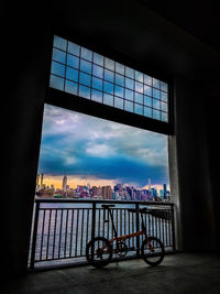 Bicycle parked on bridge over river