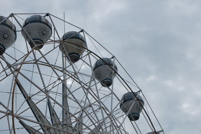 Low angle view of ferris wheel against sky