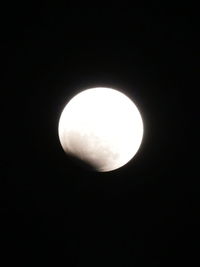 Low angle view of moon against dark sky