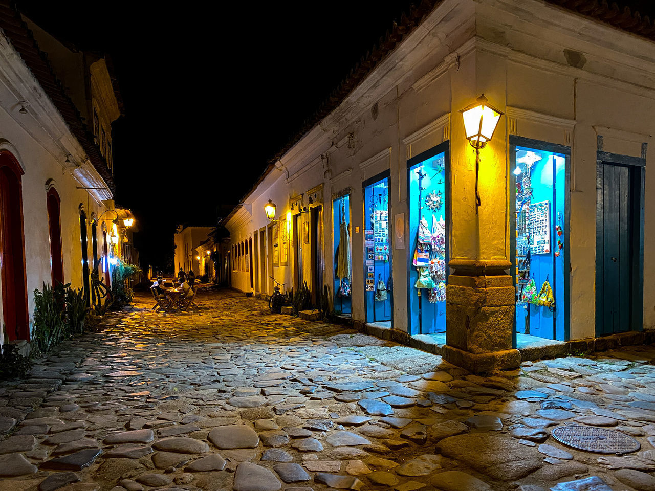 ILLUMINATED STREET AMIDST BUILDINGS