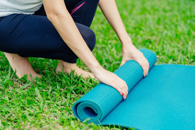 Low section of woman sitting on field