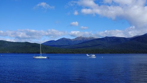 Sailboats in lake against sky