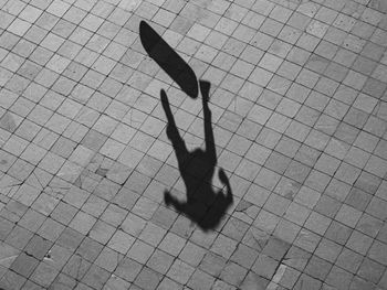 Shadow of man walking on street